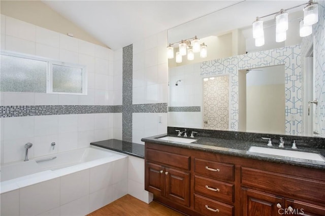 19 Byron Close, Laguna Niguel, CA 92677 - bathroom with a bath, vaulted ceiling, double vanity, tile walls, and tiled shower