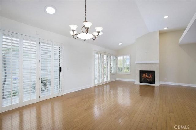 19 Byron Close, Laguna Niguel, CA 92677 - unfurnished living room with a chandelier, hardwood / wood-style flooring, vaulted ceiling, baseboards, and a fireplace with flush hearth