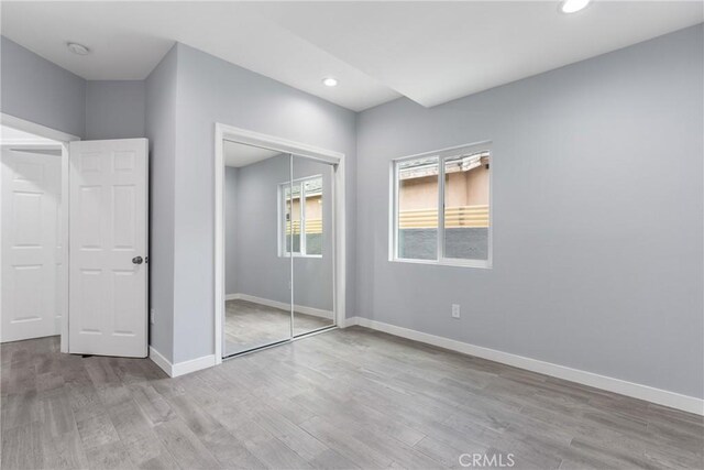7321 Eglise Ave, Pico Rivera, CA 90660 - unfurnished bedroom with light wood finished floors, recessed lighting, baseboards, and a closet
