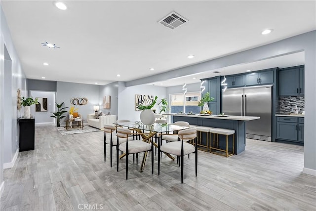 7321 Eglise Ave, Pico Rivera, CA 90660 - dining room featuring light wood-style floors, recessed lighting, and baseboards