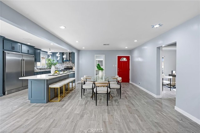 7321 Eglise Ave, Pico Rivera, CA 90660 - dining room with light wood-style floors and recessed lighting