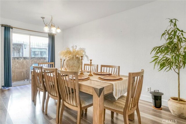9414 Moonbeam Ave Unit 18, Panorama City, CA 91402 - dining space with a chandelier, light wood-style flooring, and baseboards