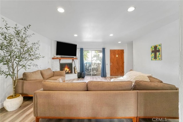 9414 Moonbeam Ave Unit 18, Panorama City, CA 91402 - living room featuring wood finished floors, recessed lighting, and a fireplace