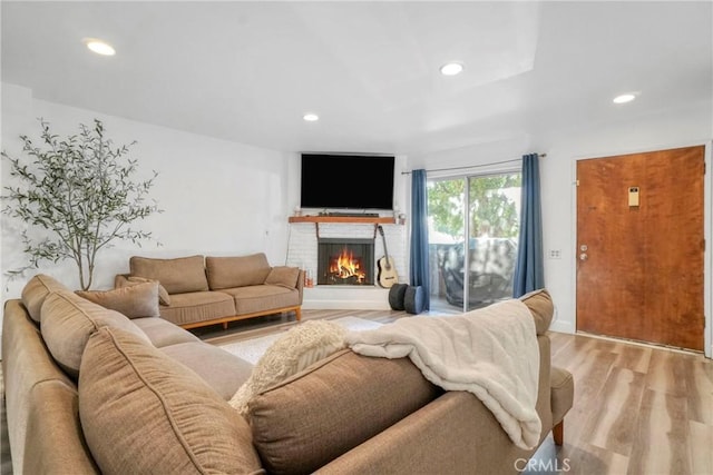 9414 Moonbeam Ave Unit 18, Panorama City, CA 91402 - living room with a brick fireplace, recessed lighting, and light wood-style flooring