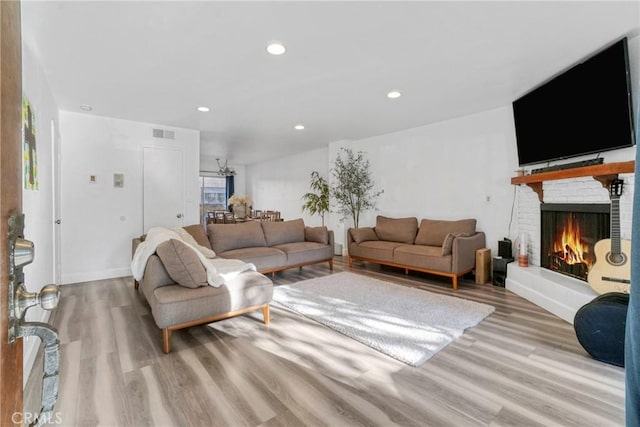 9414 Moonbeam Ave Unit 18, Panorama City, CA 91402 - living room featuring wood finished floors, a brick fireplace, recessed lighting, and baseboards
