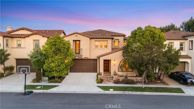 74 Gainsboro, Irvine, CA 92620 - mediterranean / spanish-style house featuring a tiled roof, a garage, concrete driveway, and stucco siding
