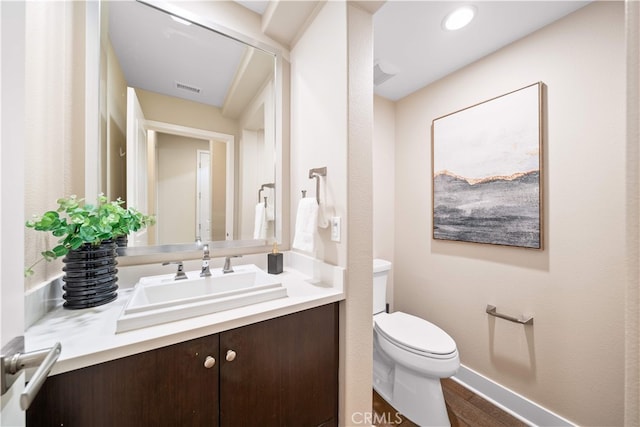 74 Gainsboro, Irvine, CA 92620 - half bath with toilet, vanity, baseboards, and wood finished floors
