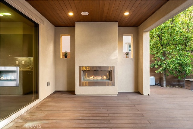 74 Gainsboro, Irvine, CA 92620 - view of patio / terrace with a glass covered fireplace and a deck