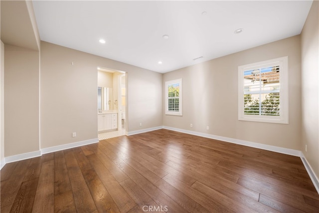 74 Gainsboro, Irvine, CA 92620 - spare room featuring dark wood-style flooring, baseboards, and recessed lighting