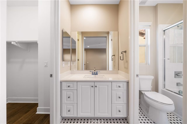 74 Gainsboro, Irvine, CA 92620 - full bath featuring vanity, enclosed tub / shower combo, wood finished floors, toilet, and baseboards