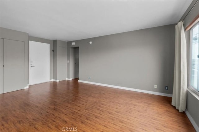 525 N Sycamore Unit 320, Los Angeles, CA 90036 - empty room featuring wood finished floors, healthy amount of natural light, and baseboards