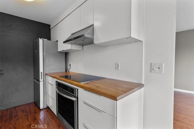 525 N Sycamore Unit 320, Los Angeles, CA 90036 - kitchen featuring stainless steel appliances, under cabinet range hood, white cabinetry, dark wood-type flooring, and butcher block counters
