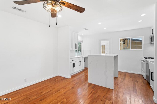 260262 Acacia St, Altadena, CA 91001 - kitchen with gas range gas stove, a ceiling fan, stainless steel microwave, wood-type flooring, and recessed lighting