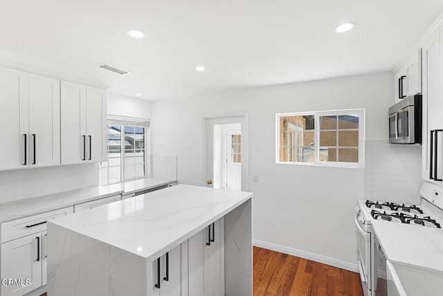260262 Acacia St, Altadena, CA 91001 - kitchen with stainless steel microwave, white gas range, a kitchen island, dark wood-type flooring, and light stone countertops