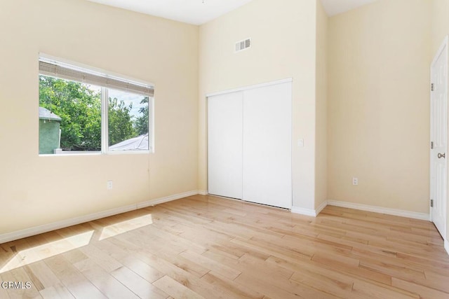 260262 Acacia St, Altadena, CA 91001 - unfurnished bedroom with light wood-type flooring, baseboards, a closet, and a high ceiling