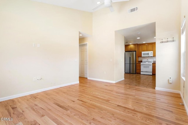 260262 Acacia St, Altadena, CA 91001 - unfurnished living room featuring light wood-style flooring, a high ceiling, ceiling fan, baseboards, and recessed lighting