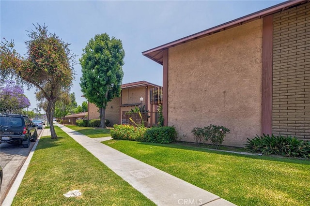 5905 Rosemead Blvd Unit 16, Pico Rivera, CA 90660 - view of side of home with a yard and stucco siding