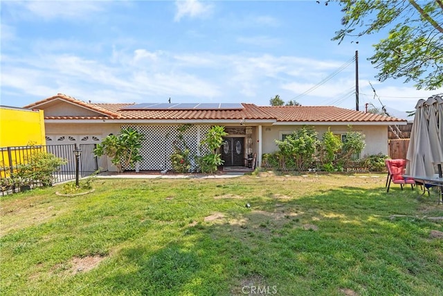 25785 Edgemont Ct, San Bernardino, CA 92404 - view of front facade featuring solar panels, stucco siding, a tiled roof, and a garage