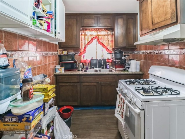 119 W 61st St, Los Angeles, CA 90003 - kitchen featuring white gas range, under cabinet range hood, a sink, tile walls, and light countertops