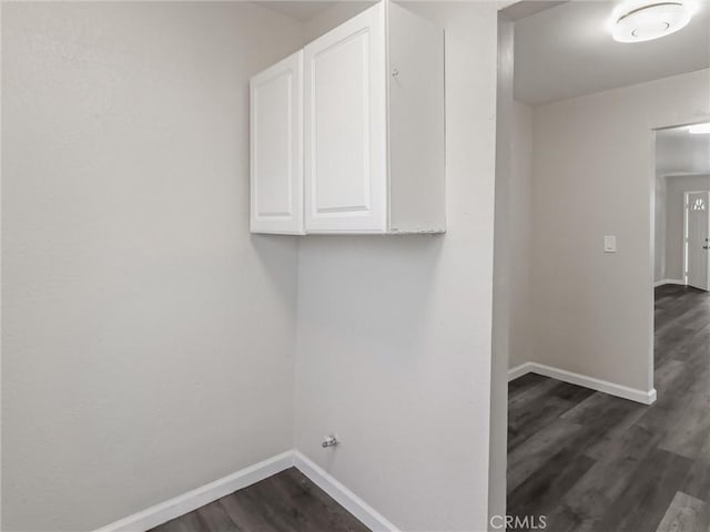 119 W 61st St, Los Angeles, CA 90003 - laundry area featuring dark wood-style flooring, baseboards, and cabinet space