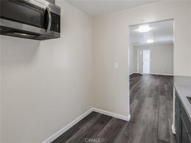 119 W 61st St, Los Angeles, CA 90003 - corridor with dark wood-style flooring and baseboards