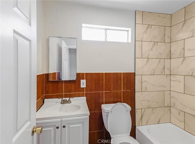 119 W 61st St, Los Angeles, CA 90003 - bathroom featuring vanity, toilet, tile walls, wainscoting, and shower / bathtub combination