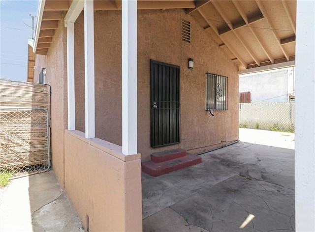 119 W 61st St, Los Angeles, CA 90003 - doorway to property with stucco siding and a patio