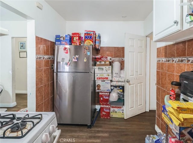 119 W 61st St, Los Angeles, CA 90003 - kitchen with freestanding refrigerator, tile walls, dark wood finished floors, white cabinets, and white range with gas cooktop