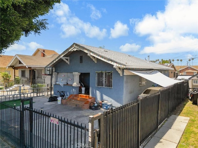 119 W 61st St, Los Angeles, CA 90003 - bungalow-style house featuring stucco siding and a fenced front yard