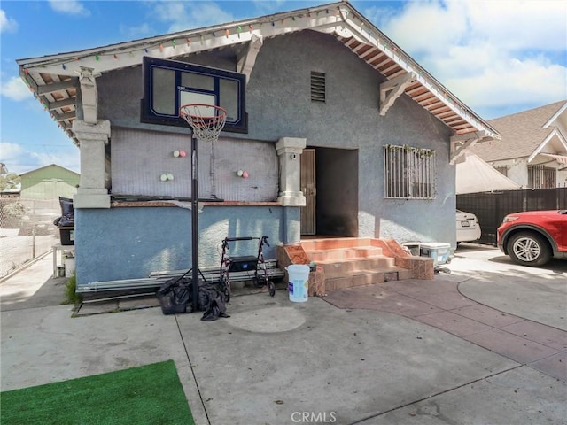 119 W 61st St, Los Angeles, CA 90003 - back of property featuring stucco siding and a patio area