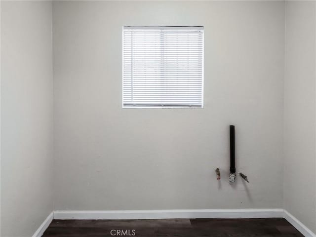119 W 61st St, Los Angeles, CA 90003 - unfurnished room with baseboards and dark wood-style flooring