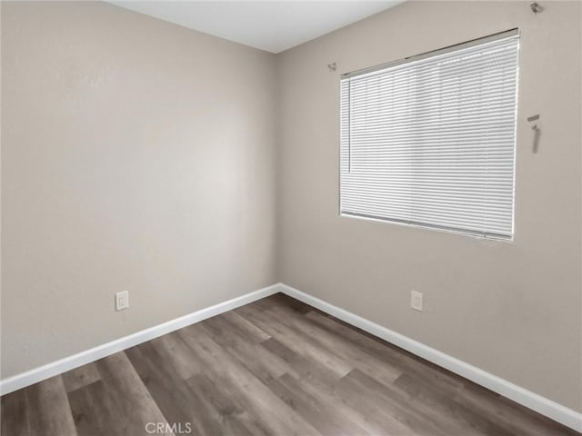 119 W 61st St, Los Angeles, CA 90003 - unfurnished room featuring baseboards and dark wood-type flooring
