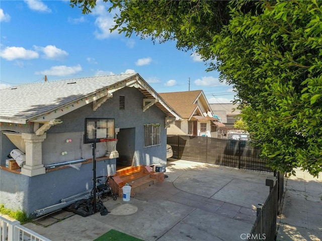 119 W 61st St, Los Angeles, CA 90003 - rear view of house with stucco siding, a patio area, and a shingled roof