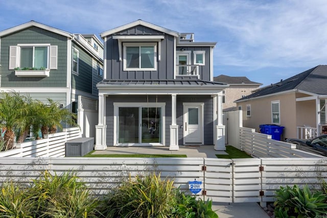 867 Wilbur Ave, San Diego, CA 92109 - view of front facade featuring board and batten siding, a fenced front yard, and a porch
