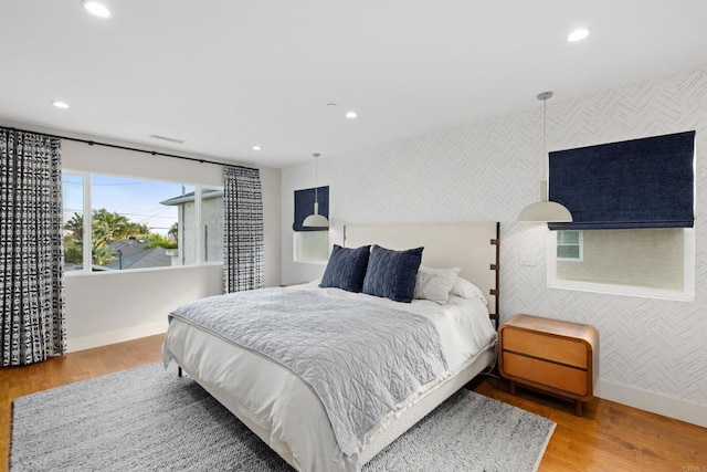 867 Wilbur Ave, San Diego, CA 92109 - bedroom with baseboards, recessed lighting, wood finished floors, wallpapered walls, and an accent wall