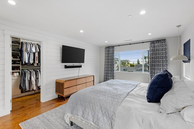 867 Wilbur Ave, San Diego, CA 92109 - bedroom featuring light wood-type flooring, recessed lighting, a walk in closet, wooden walls, and a closet