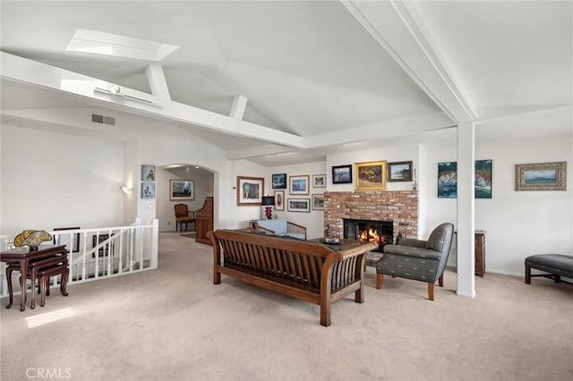 790 Wendt Ter, Laguna Beach, CA 92651 - carpeted living room with lofted ceiling, arched walkways, and a brick fireplace