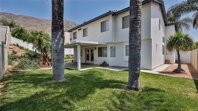 22820 Lark St, Grand Terrace, CA 92313 - back of house featuring stucco siding, french doors, a patio, and a mountain view