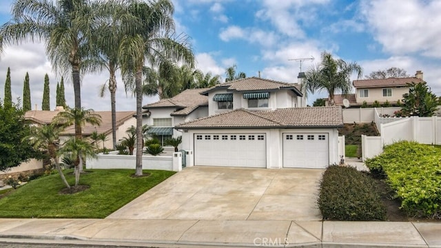 22820 Lark St, Grand Terrace, CA 92313 - mediterranean / spanish house with stucco siding, driveway, a tile roof, and a garage