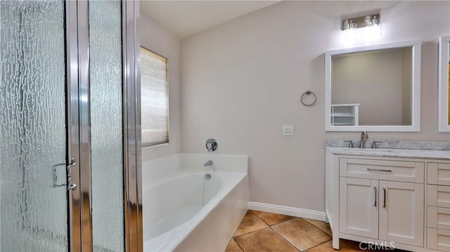 22820 Lark St, Grand Terrace, CA 92313 - bathroom featuring vanity, a garden tub, tile patterned floors, a stall shower, and baseboards