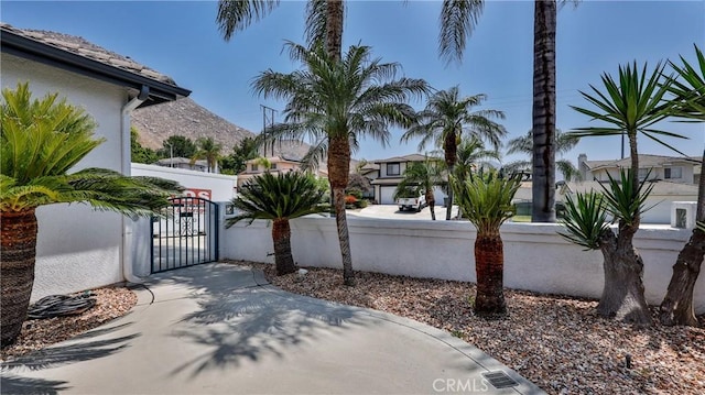 22820 Lark St, Grand Terrace, CA 92313 - view of patio / terrace featuring a gate, a fenced front yard, and a residential view