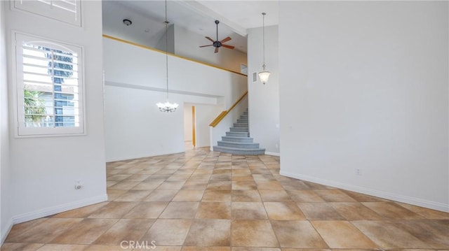 22820 Lark St, Grand Terrace, CA 92313 - spare room with ceiling fan, stairway, a chandelier, baseboards, and a towering ceiling