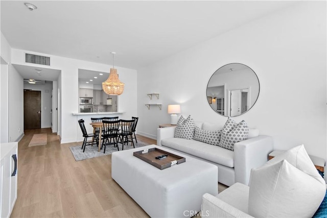 900 W Olympic Blvd Unit 34F, Los Angeles, CA 90015 - living room featuring light wood-style floors and baseboards