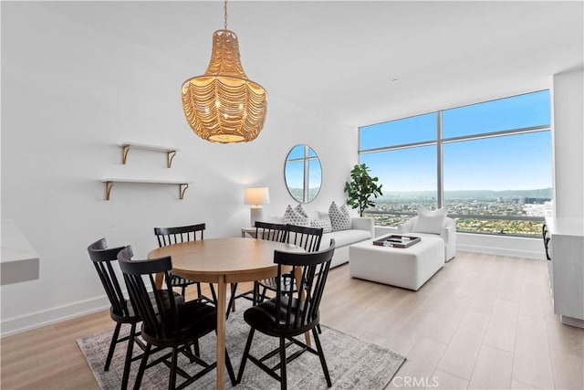900 W Olympic Blvd Unit 34F, Los Angeles, CA 90015 - dining space featuring light wood-type flooring and baseboards