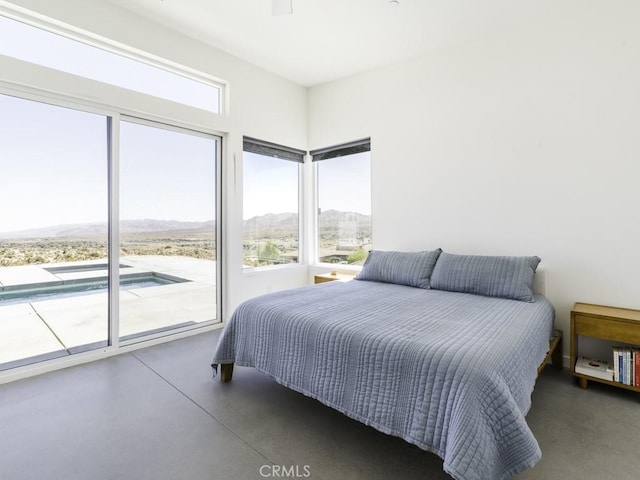 6197 Mandarin Rd, Yucca Valley, CA 92284 - bedroom featuring access to exterior, a mountain view, and concrete flooring