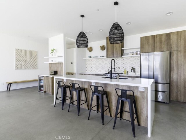 6197 Mandarin Rd, Yucca Valley, CA 92284 - kitchen with open shelves, freestanding refrigerator, finished concrete floors, and modern cabinets