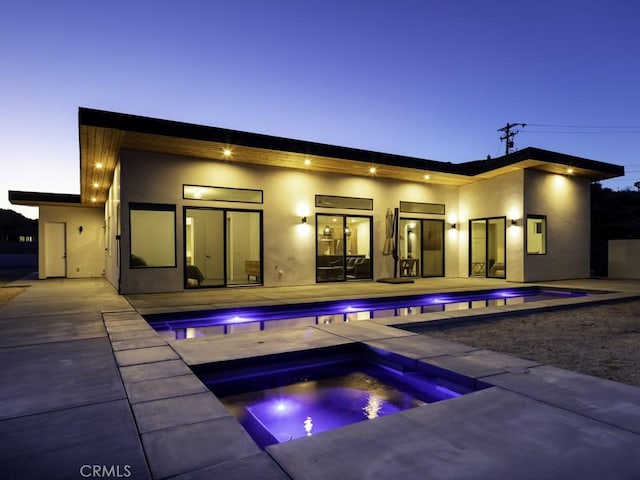 6197 Mandarin Rd, Yucca Valley, CA 92284 - rear view of property featuring an in-ground hot tub, a patio, stucco siding, and an outdoor pool