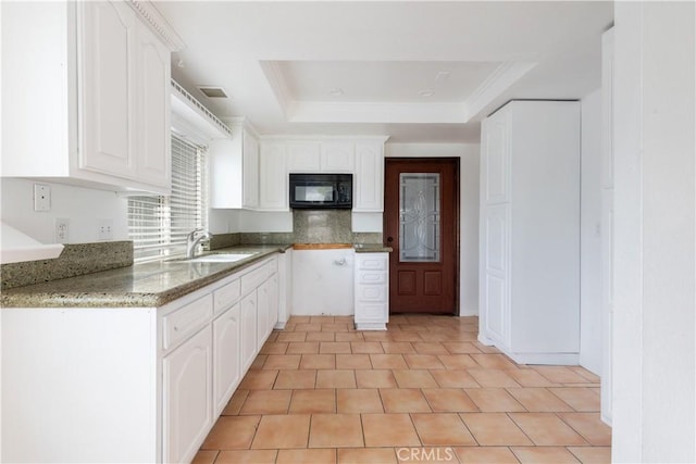 10709 Calabash Ave, Fontana, CA 92337 - kitchen with black microwave, a sink, a tray ceiling, light stone counters, and white cabinets