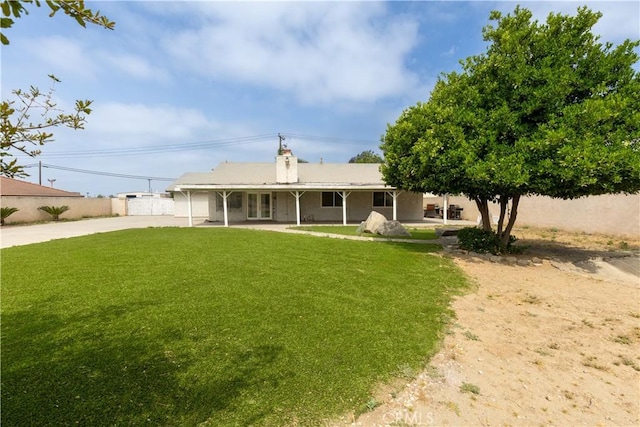 10709 Calabash Ave, Fontana, CA 92337 - rear view of house featuring driveway and a chimney