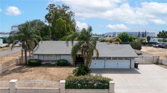 10709 Calabash Ave, Fontana, CA 92337 - view of front of house featuring a garage, concrete driveway, a fenced front yard, a gate, and stucco siding